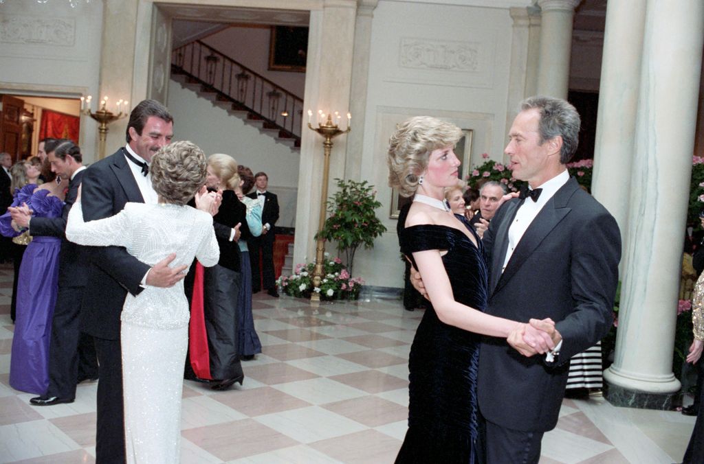 In this photo provided by the Ronald Reagan Presidential Library, Tom Selleck dances with Nancy Reagan, left, and Princess Diana and Clint Eastwood dance, right, in the Cross Hall of the White House in Washington, D.C. at a Dinner for Prince Charles and Princess Diana of the United Kingdom on November 9, 1985