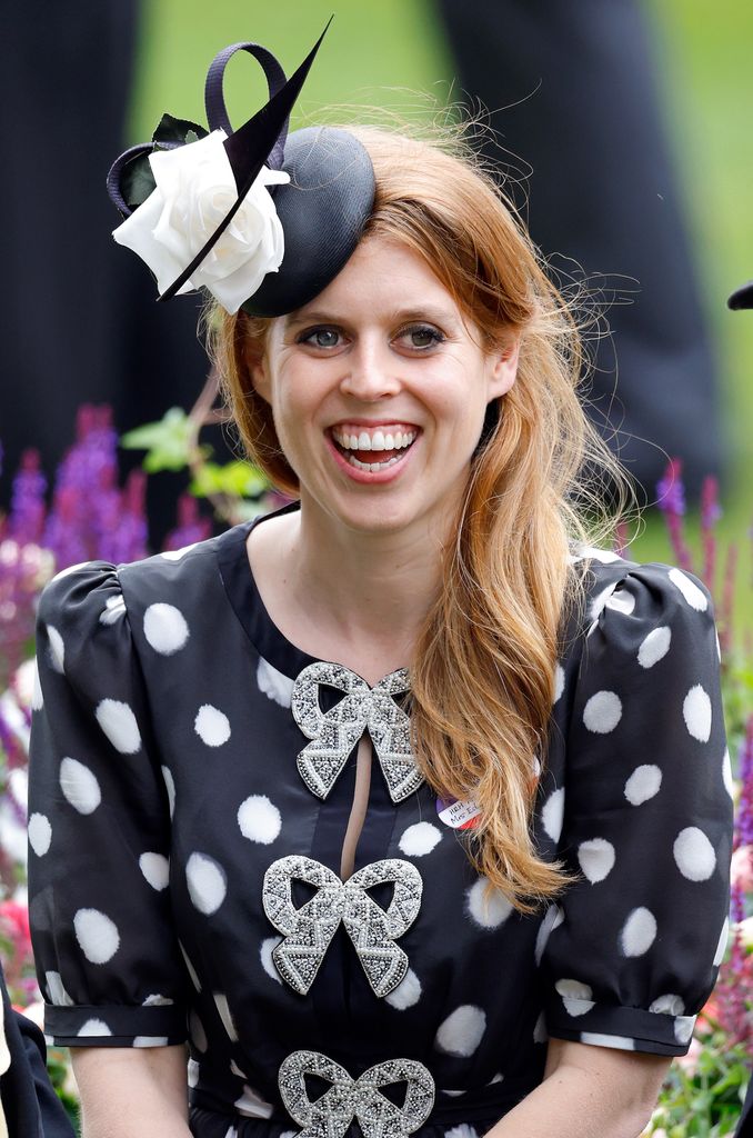 Princess Beatrice laughing in black spotty dress