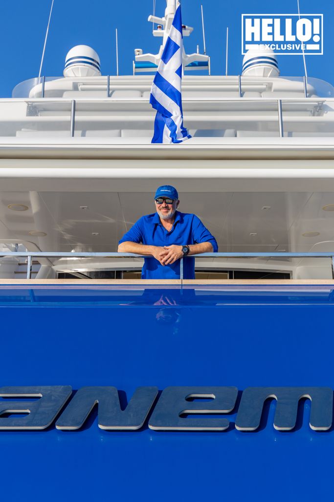 Man on the back of a blue boat