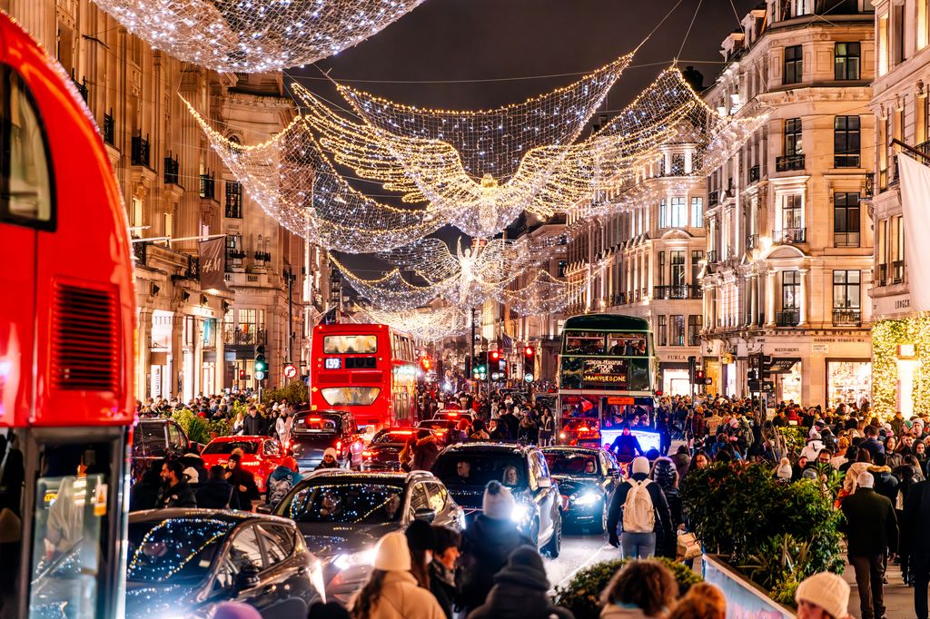 Regent Street decorated for Christmas and crowds of people, London, UK