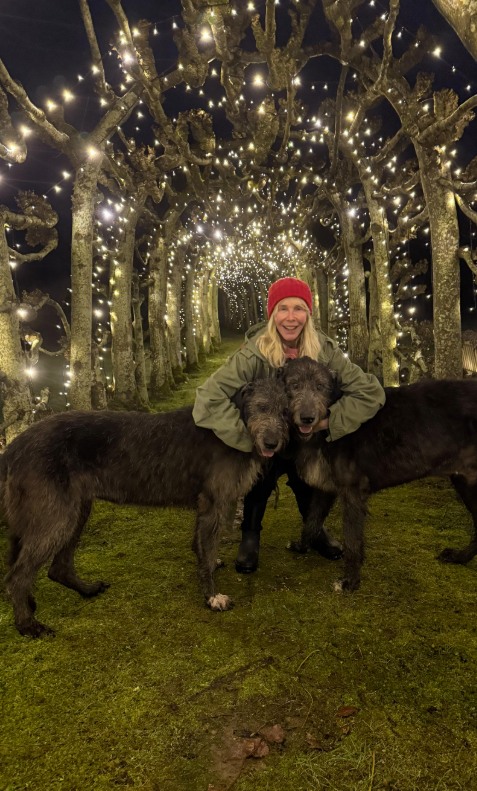 Trudie with her dogs in her garden at home in Wiltshire