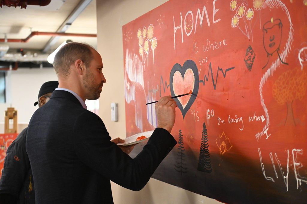 Prince William painting on a mural