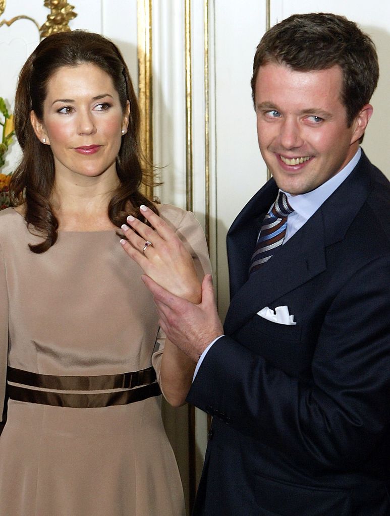 Queen Mary showing her engagement ring with King Frederik holding her hand