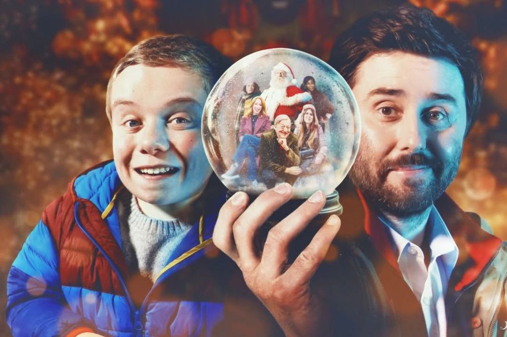 Two men either side of a snow globe