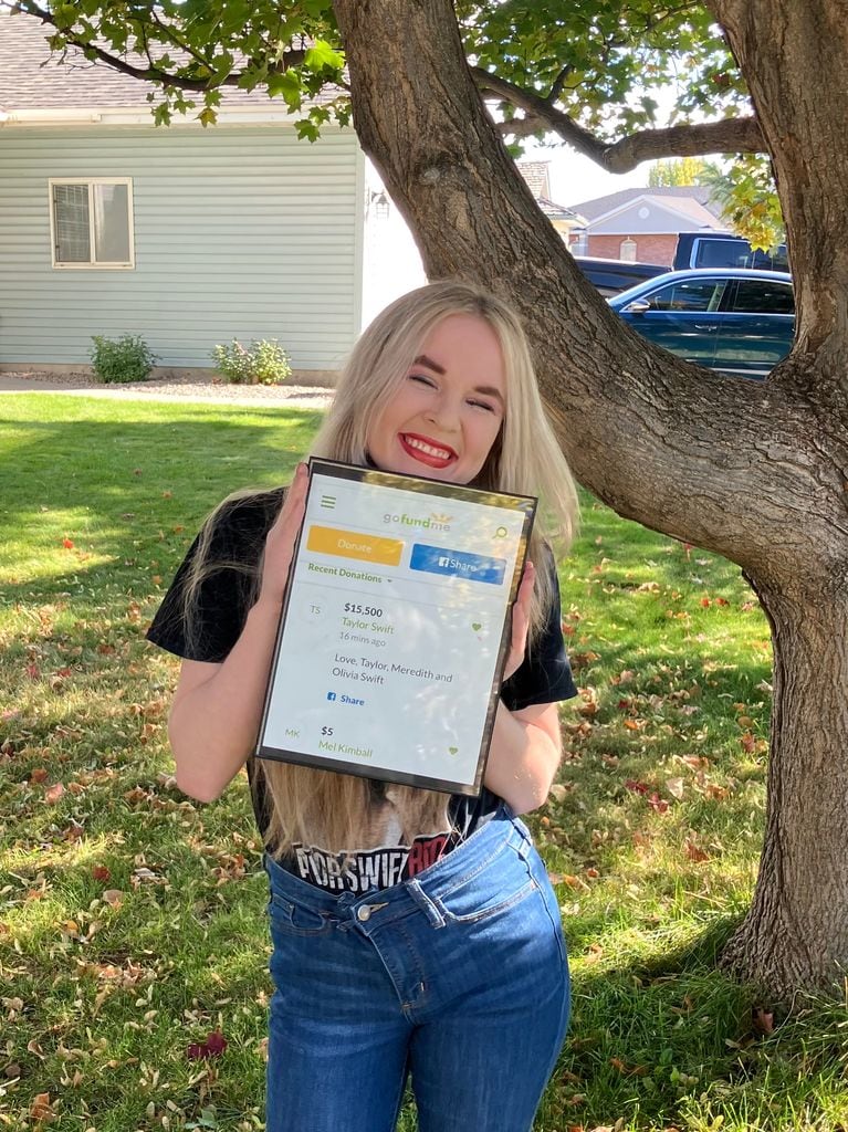 Sadie proudly holding up the donation from Taylor 