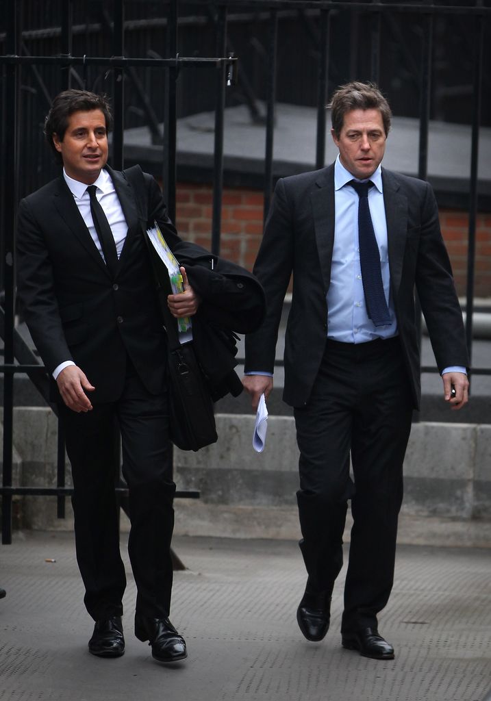 David Sherborne walking alongside Hugh Grant