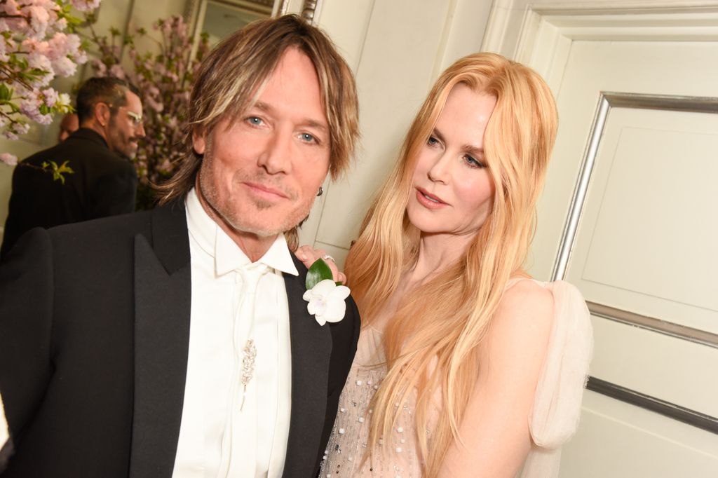 Keith Urban In a suit and Nicole Kidman in a sparkly nude pink dress