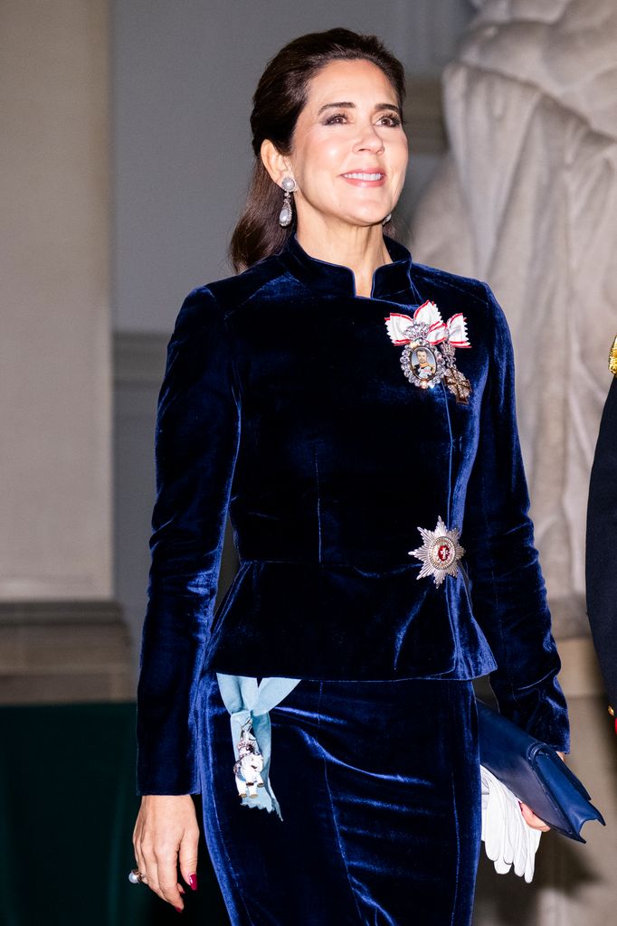 Queen Mary of Denmark in navy velvet jacket with medals