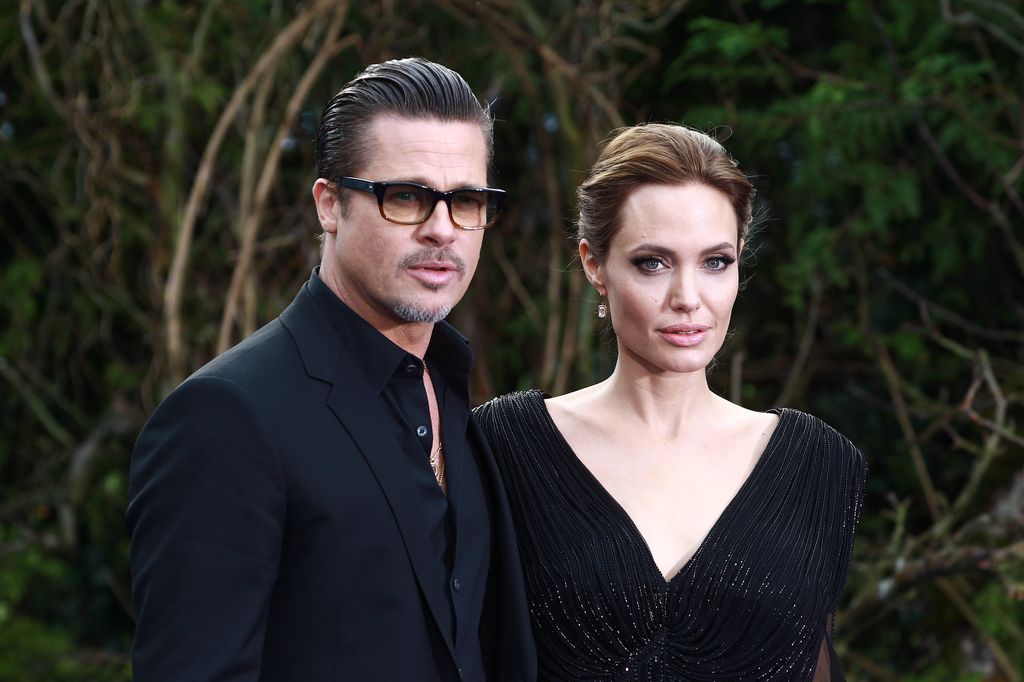 Brad Pitt and Angelina Jolie attend a private reception as costumes and props from Disney's "Maleficent" are exhibited in support of Great Ormond Street Hospital at Kensington Palace in 2014 i
