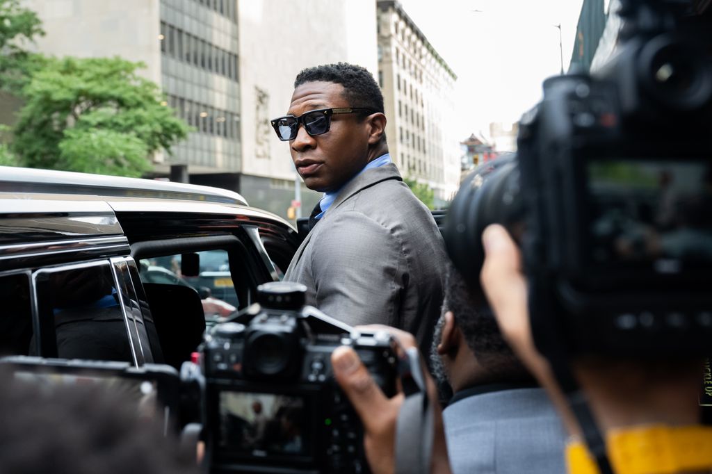 Jonathan Majors, looks backs at media while leaving Manhattan Criminal court after his pre trial hearing on August 03, 2023 in New York City. If convicted, Majors could face up to a year in jail over misdemeanor charges of assault and harassment.