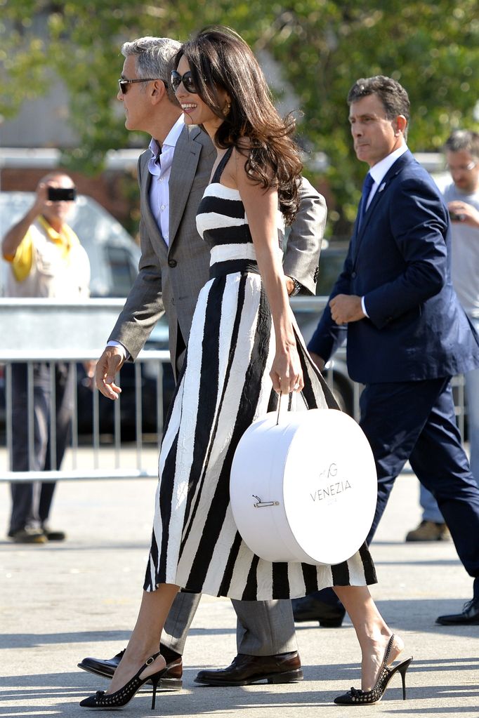 Amal wearing stripes walking with george