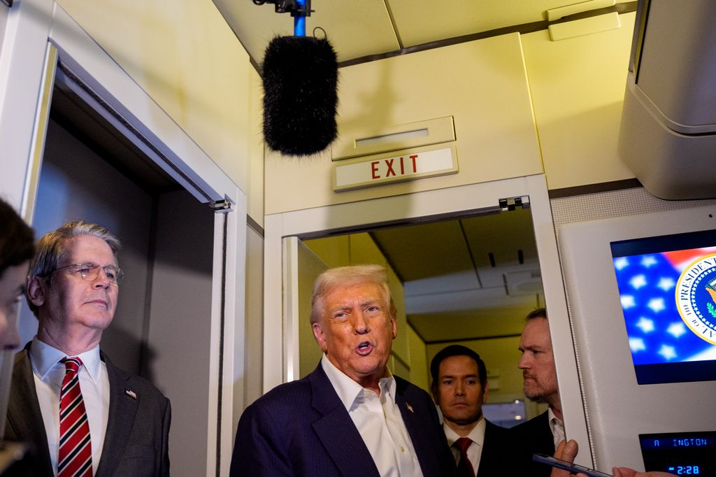 U.S. President Donald Trump, accompanied by U.S. Secretary of State Marco Rubio, (2nd R), U.S. Treasury Secretary Scott Bessent (L), and U.S. Trade Representative Jamieson Greer (R), speaks to members of the media aboard Air Force One on October 27, 2025, in flight