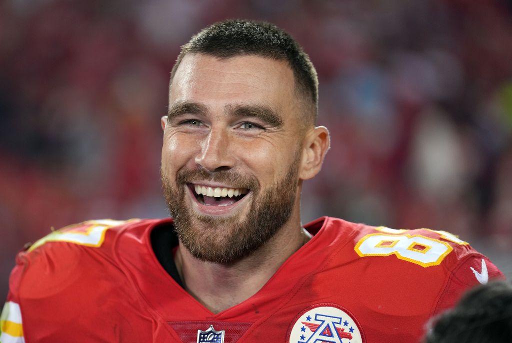 Travis Kelce smiling in his Kansas City Chiefs jersey