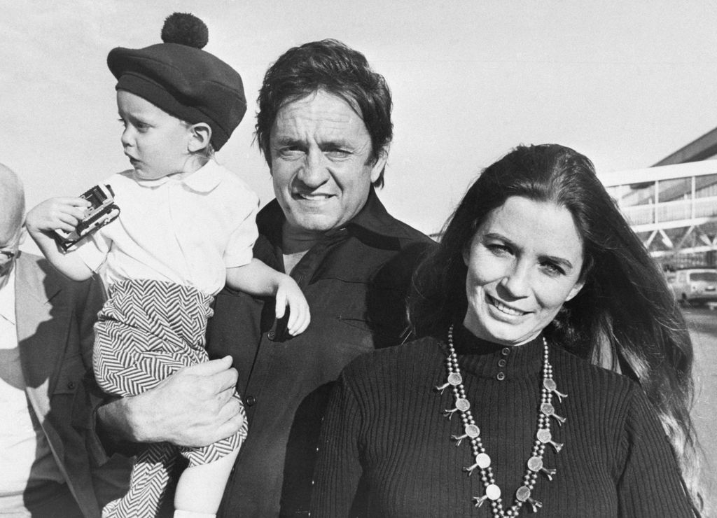 johnny cash holding son john cash as a child while posing for photo with june carter cash