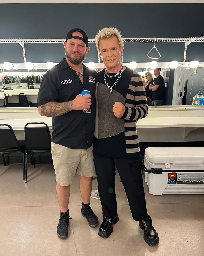 Billy Idol and his son Brant Broad pose for a photo backstage at a concert, shared on Instagram