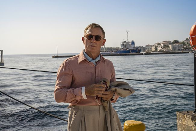 Daniel Craig stands at the port in Glass Onion