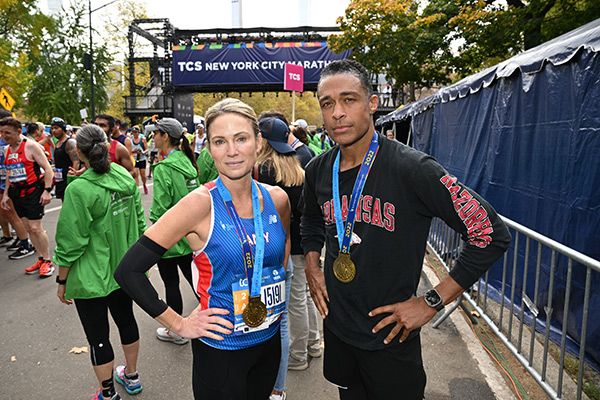Amy Robach poses with hands on hips with T.J. Holmes