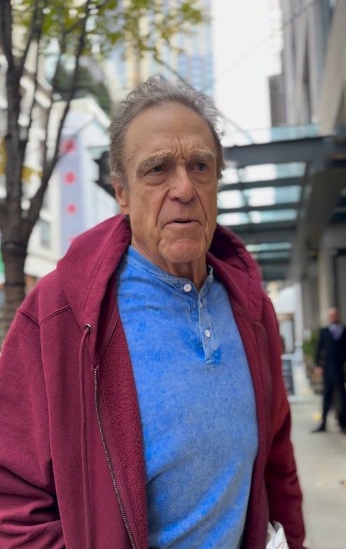 photo of john goodman in blue top and red hoodie after weight loss