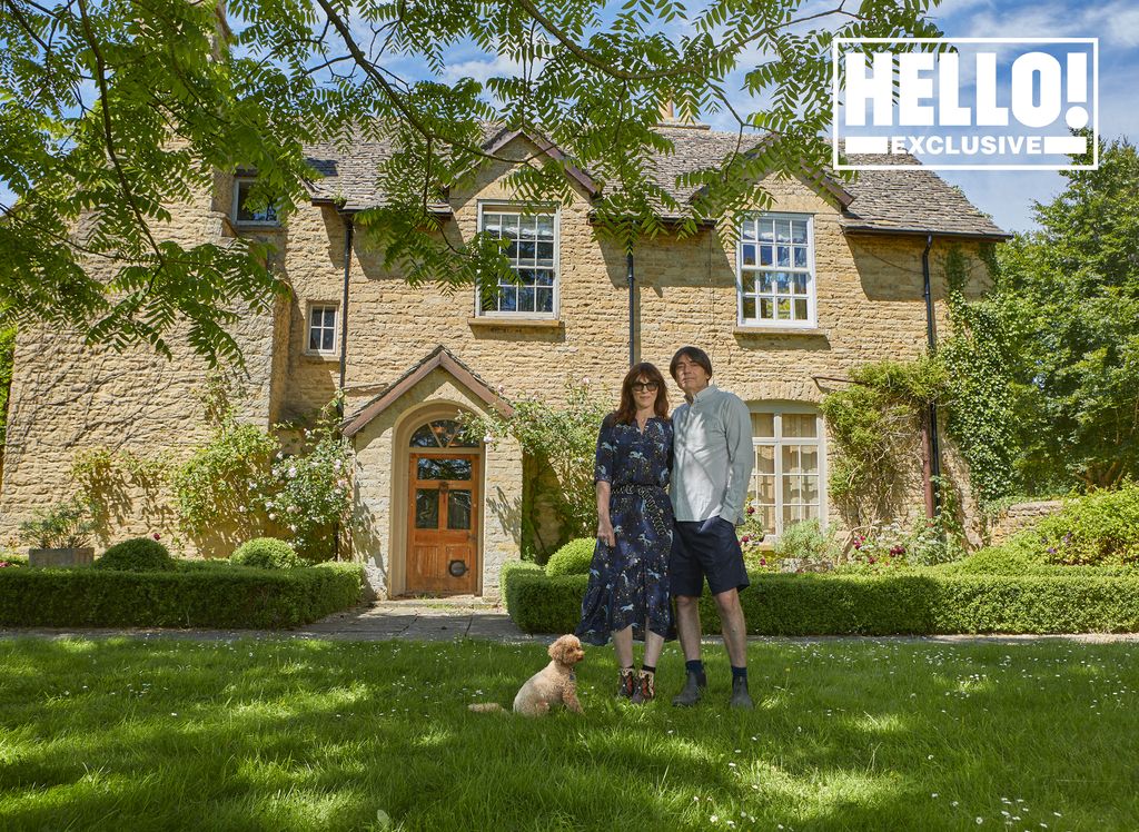 Blur star Alex James with wife Claire and pet dog posing outside farmhouse in Kingham, Oxfordshire 