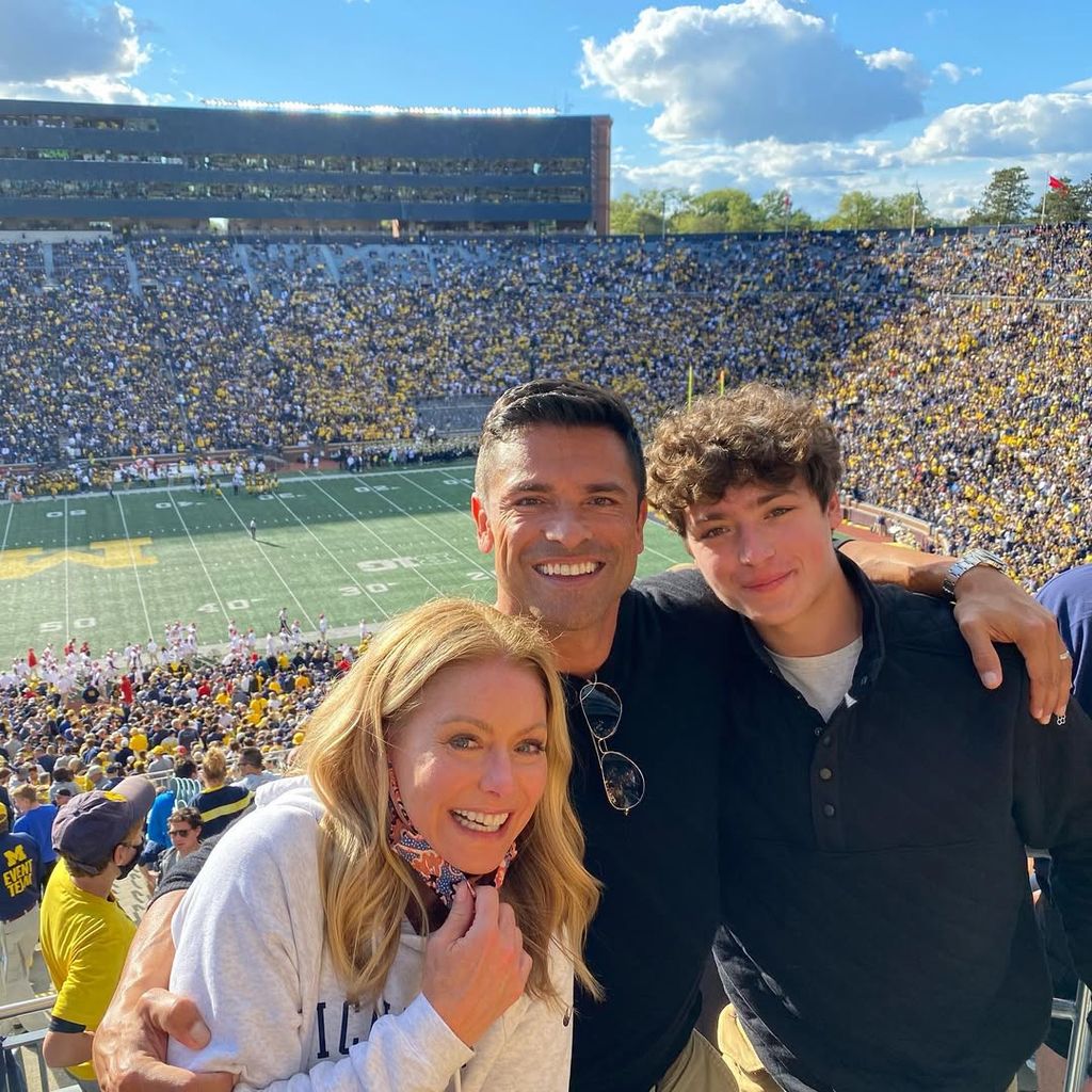 Kelly Ripa, Mark Consuelos and Joaquin Consuelos pose for a photo at a University of Michigan football game, shared on Instagram