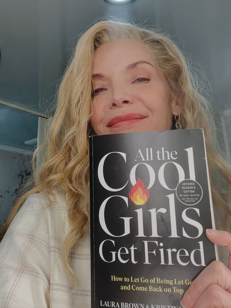 Michelle Pfeiffer posing for a selfie with book