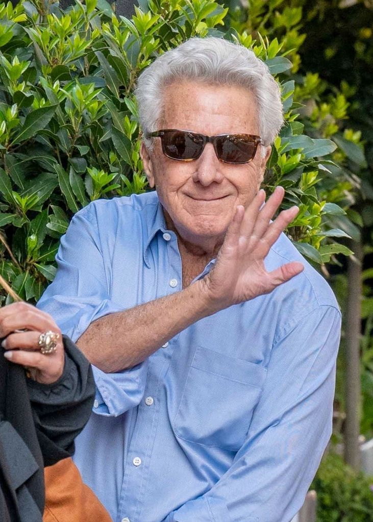 Dustin Hoffman smiles and waves for the camera