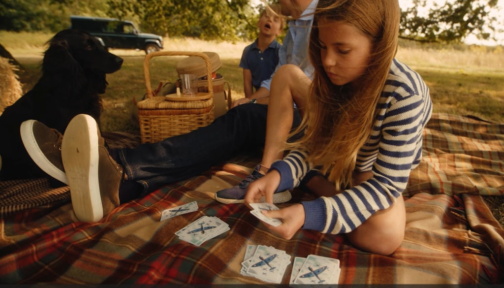 Princess Charlotte playing card game during family picnic