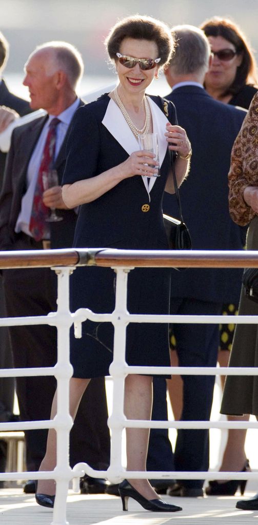 Princess Anne smiling in sunglasses and red lipstick