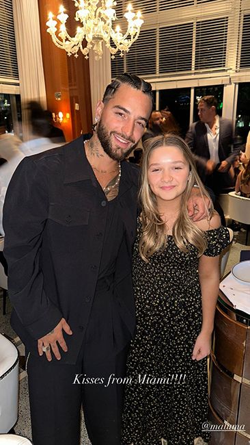 harper beckham in floral dress posing with maluma at marc anthony wedding