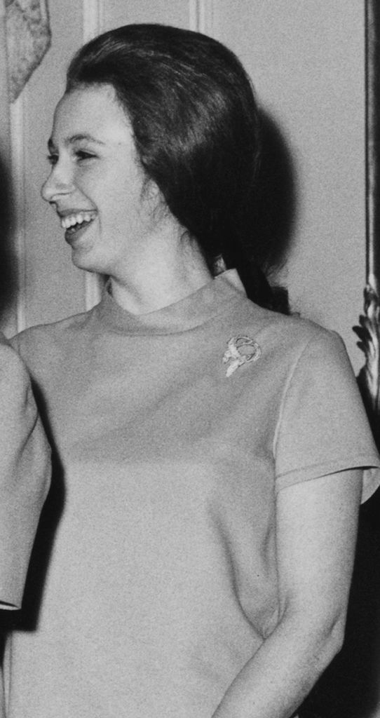 Princess Anne wearing a gold ribbon brooch at palace in 1969