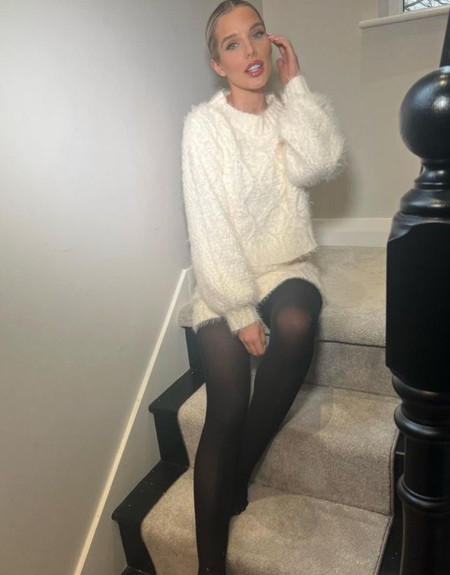 Helen Flanagan on stairs in woollen jumper and tights