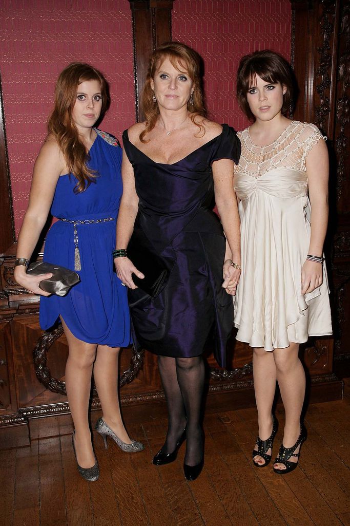 Princess Beatrice standing with Sarah Ferguson and Princess Eugenie
