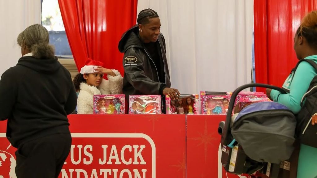 Travis Scott with daughter Stormi at Cactus Jack Foundation toy drive