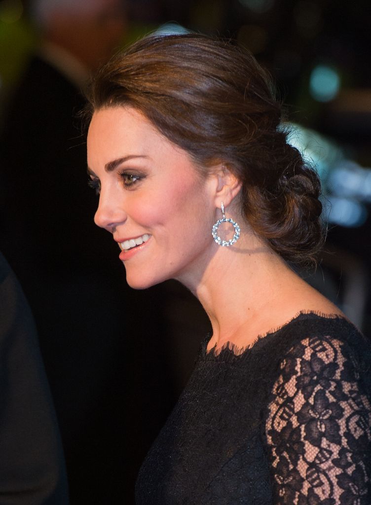 Catherine, Duchess of Cambridge smiling wearing a black dress