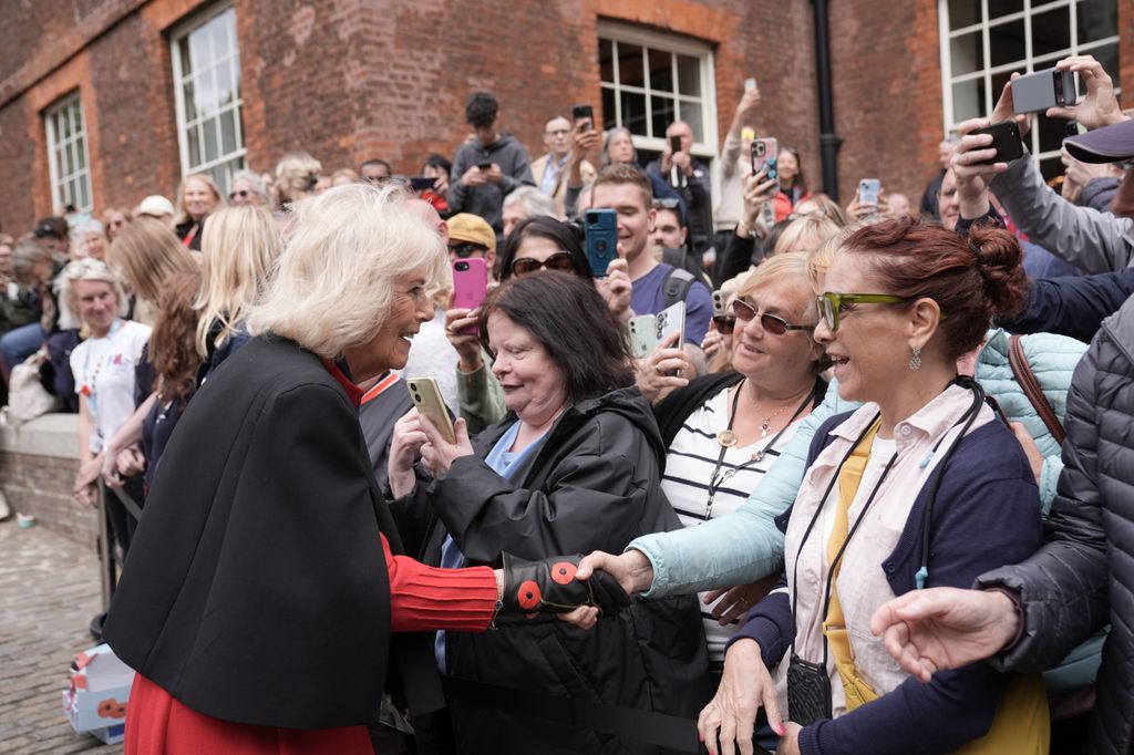 Queen Camilla speaks to members of the public during a visit to view 'The Tower Remembers'