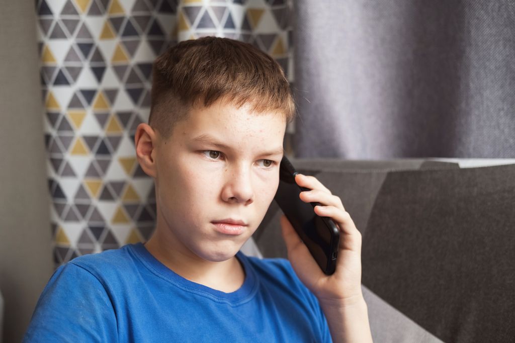 teenage boy on phone