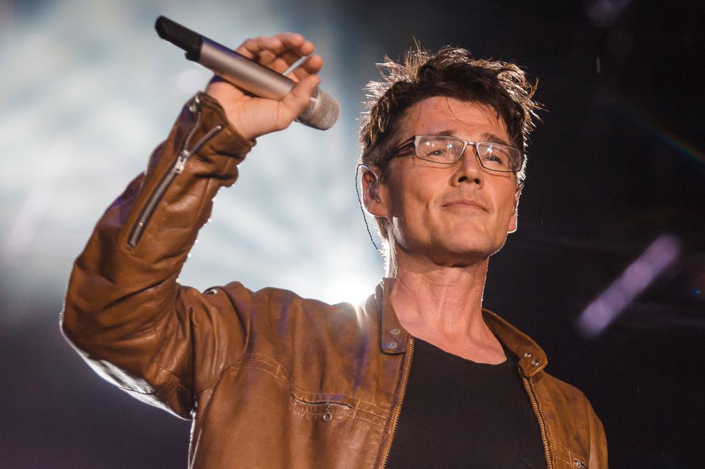 Morton Harket performing in a brown leather jacket