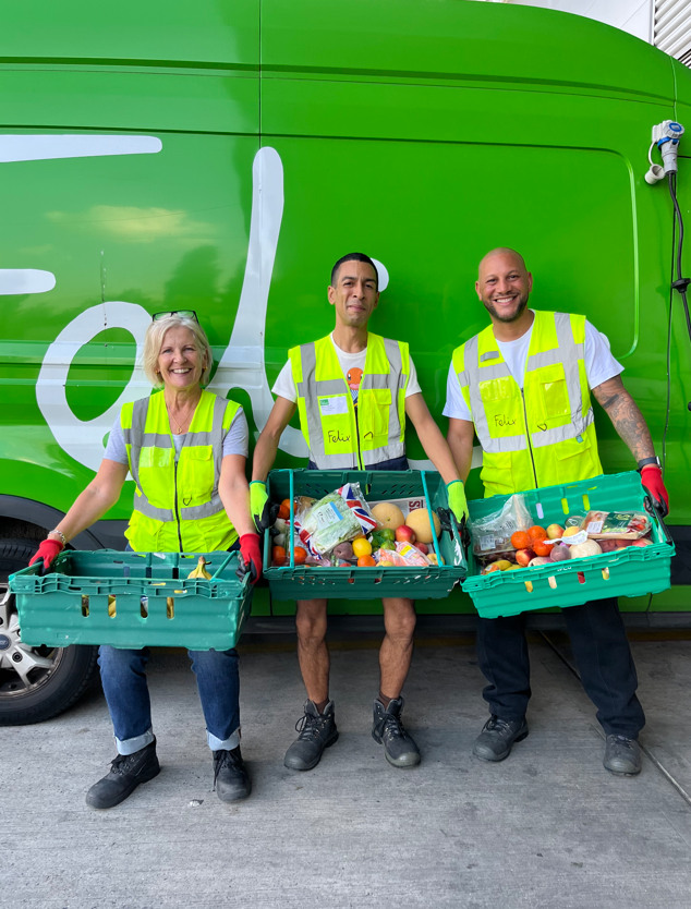 The Felix Project volunteers holding crates of fruit