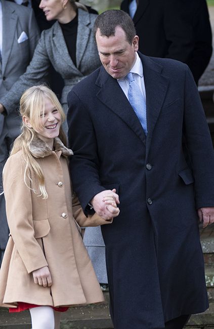 Peter Phillips and his daughter Isla hold hands outside church in Sandringham