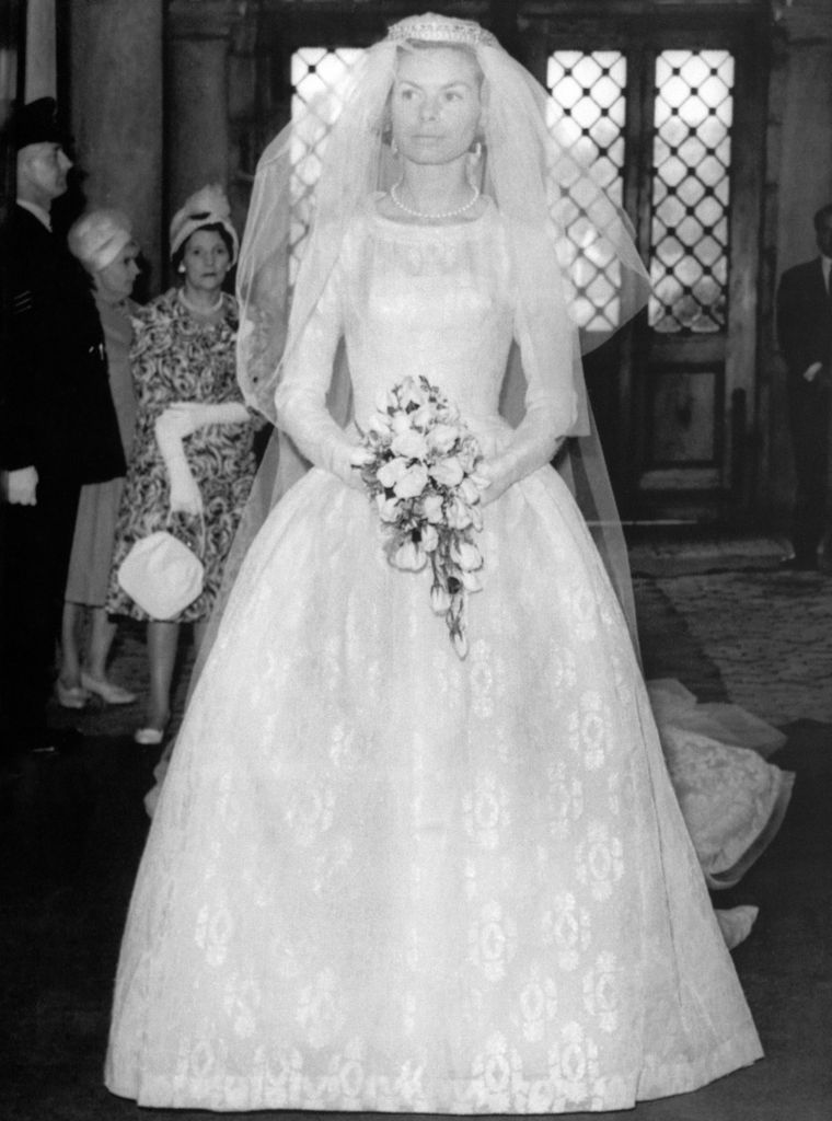 Holding her bouquet of roses, Katharine Worsley in bridal gown