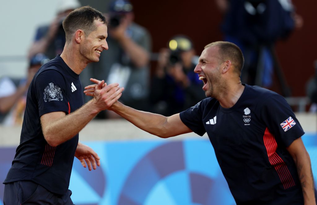 two tennis players celebrating on court