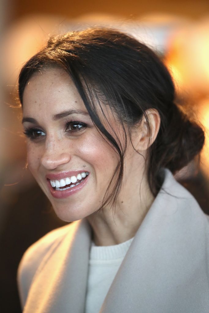 Meghan Markle smiling with messy hair
