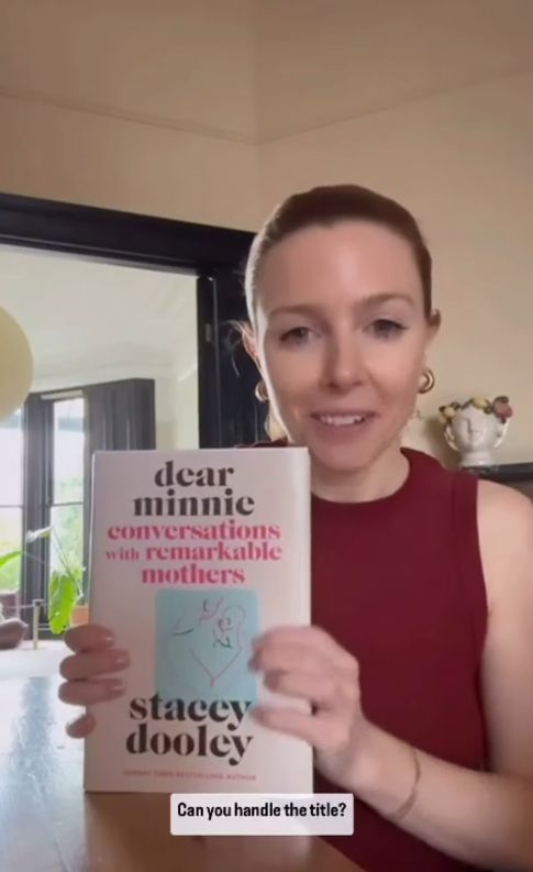 Stacey Dooley holding up a book