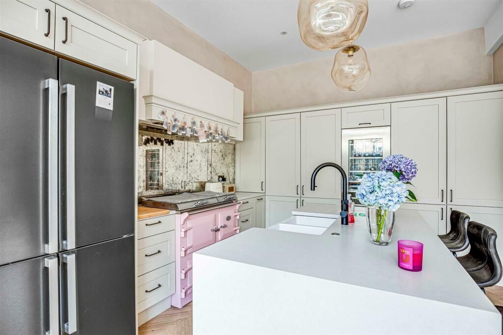 Tiffany's neutral kitchen with a pink aga