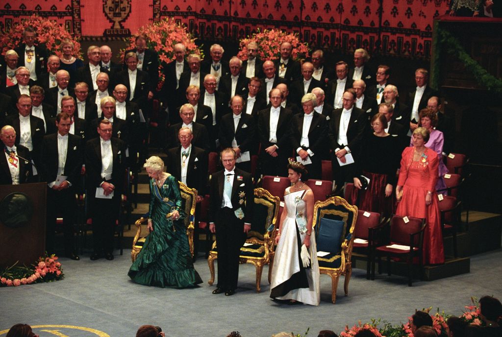 Queen Silvia on stage with men in white tie in 1994