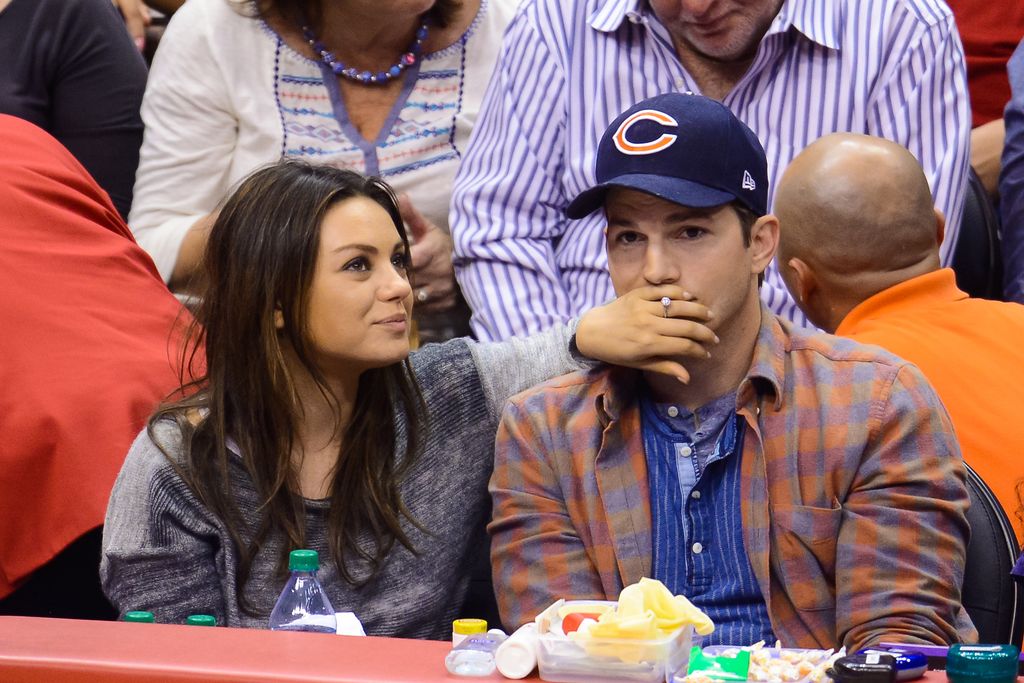 Mila Kunis and Ashton Kutcher at basketball game