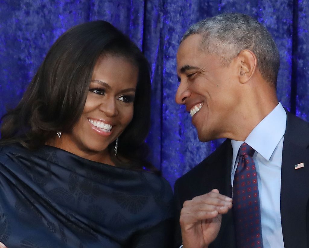 Former U.S. President Barack Obama and first lady Michelle Obama participate in the unveiling of their official portraits during a ceremony at the Smithsonian's National Portrait Gallery, on February 12, 2018 in Washington, DC. The portraits were commissioned by the Gallery, for Kehinde Wiley to create President Obama's portrait, and Amy Sherald that of Michelle Obama