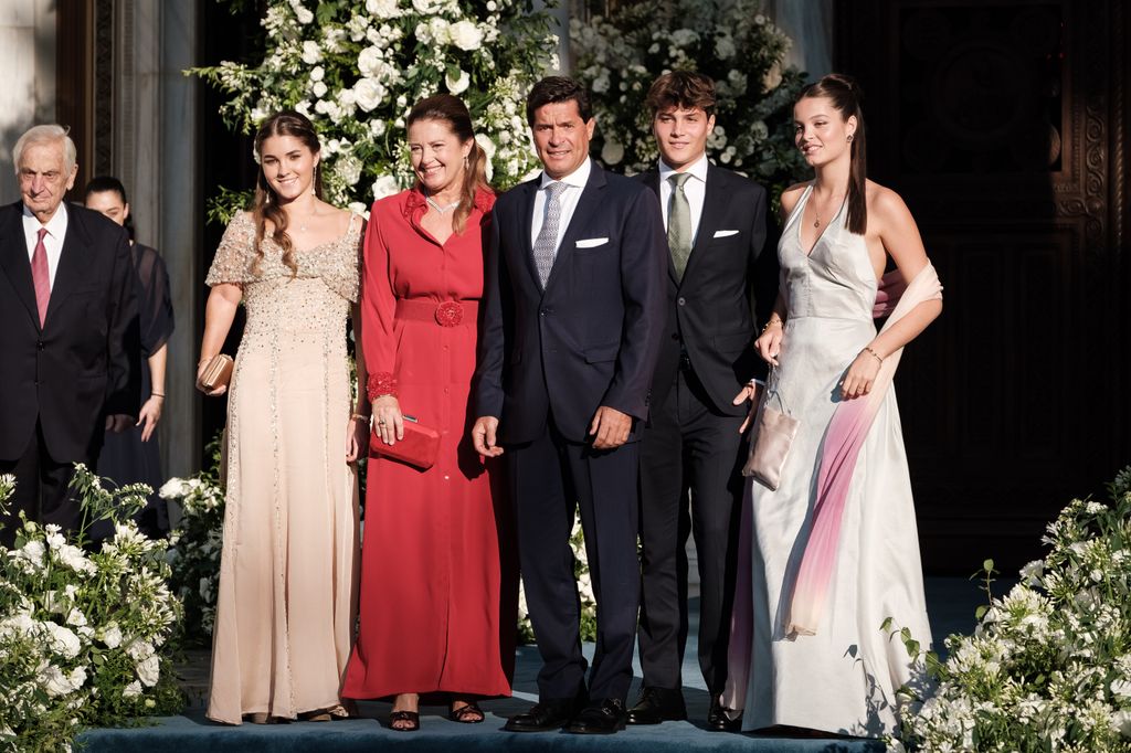 Amelia Morales y de Grecia (R) wears a white satin halterneck dress to the wedding of Princess Theodora of Greece and Matthew Kumar