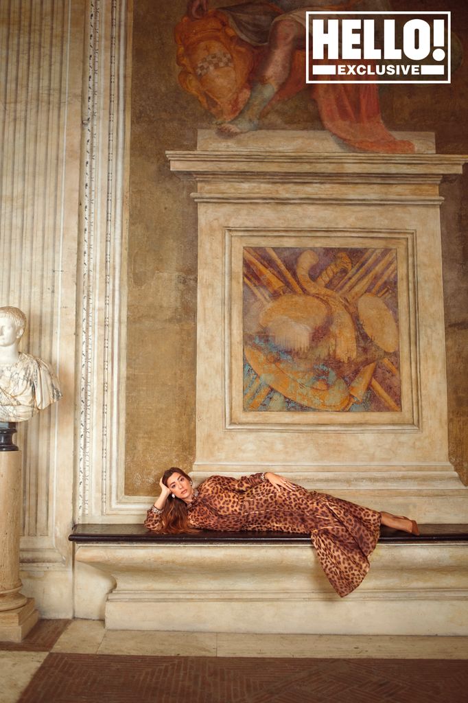 Giorgina lying down on a marble surface in The Palazzo Spinola in Genoa 