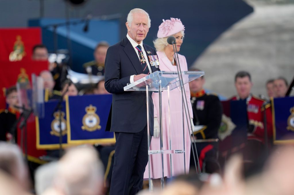 king charles and camilla on stage during D-Day anniversary ceremony 